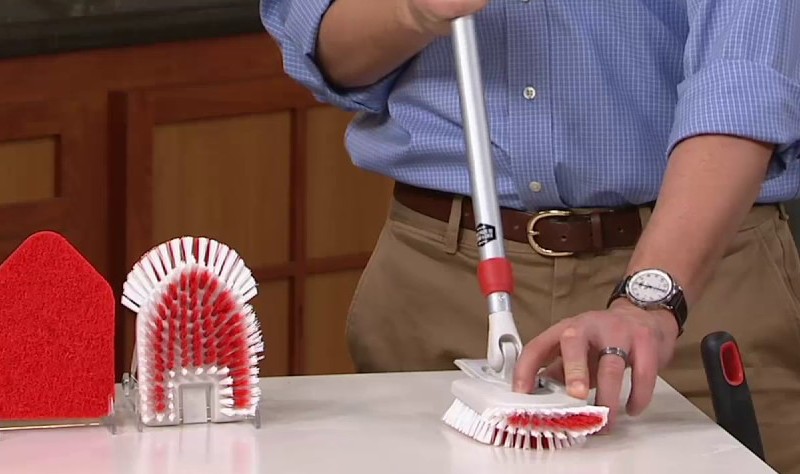 cropped image of a man with OXO Good Grips Tub and Tile Scrubber