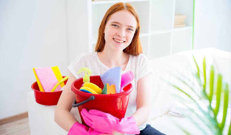 Woman with a red basket filled with tools.