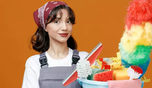 young woman with a bucket of cleaning products