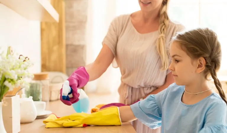 A mother is trying to teach her daughter about cleaning