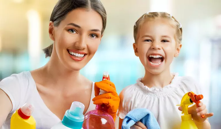 young mother and her daughter with some cleaning supplies