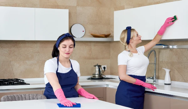 Cleaning service team cleaning kitchen