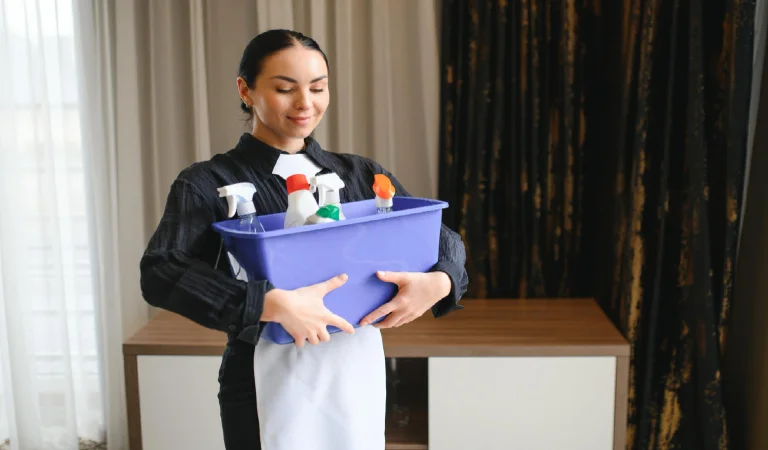 Housekeeper or maid cleaning room