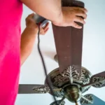 Midsection of man holding fan