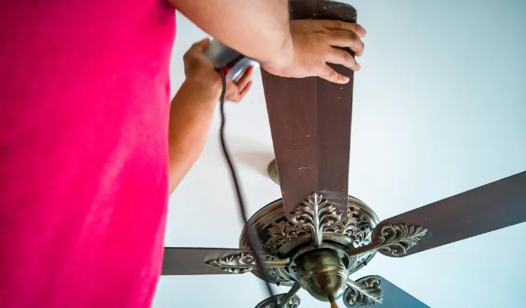 Midsection of man holding fan